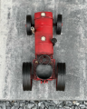 Plechový červený retro traktor